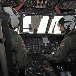 Pilots monitor gauges on the console of an MH-53E