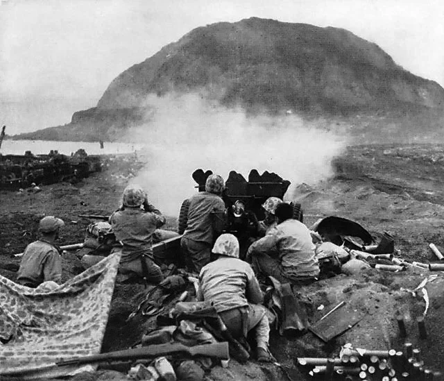 37mm_Gun_fires_against_cave_positions_at_Iwo_Jima.webp