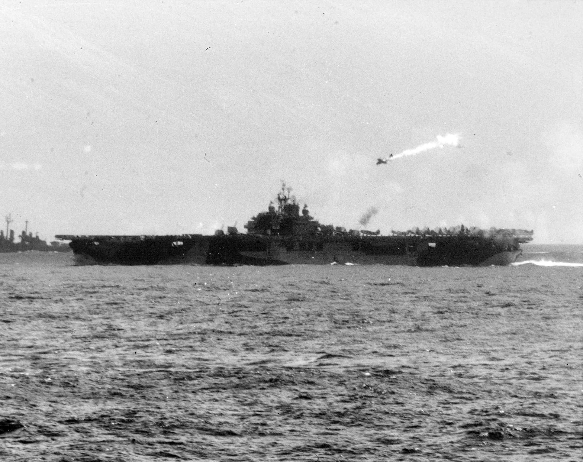 A kamikaze pictured moments before hitting the carrier Essex (CV 9) operating off the Philipp...webp