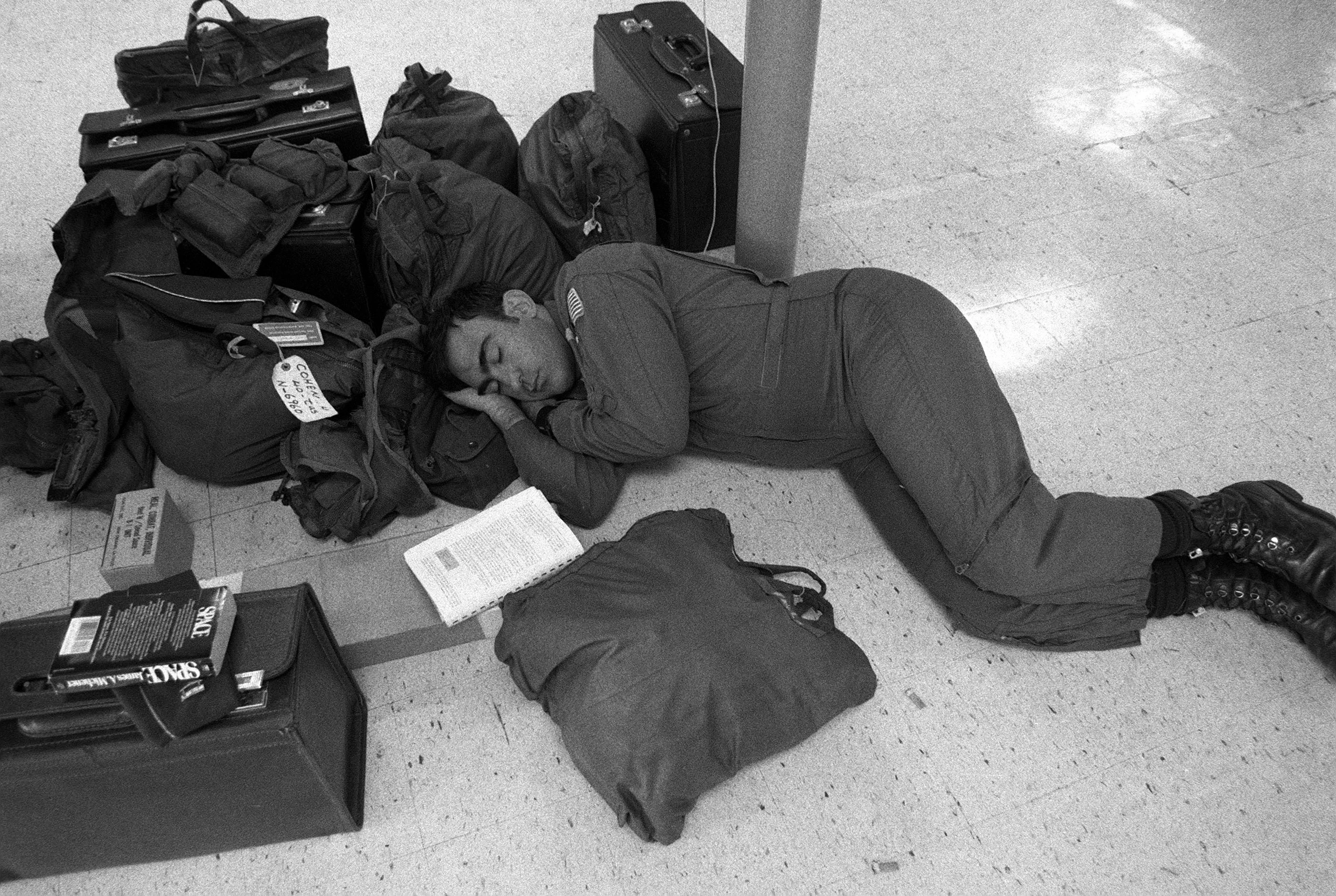 a-member-of-the-us-air-force-rests-near-his-baggage-during-the-multiservice-3b6a90.jpg