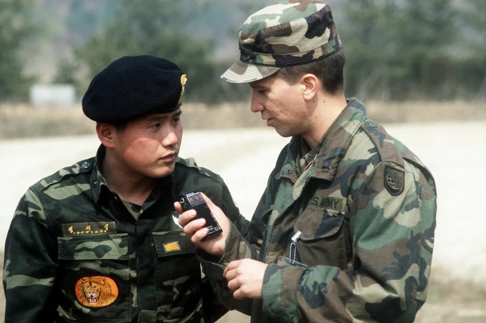 a-south-korean-soldier-and-an-american-soldier-converse-after-a-parachute-jump-c370cb-1600.webp