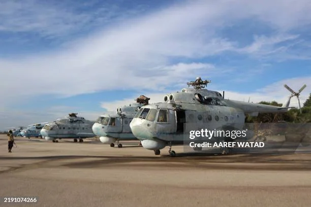 a-syrian-rebel-fighter-stands-before-russian-built-syrian-air-force-mil-mi-14-military.webp