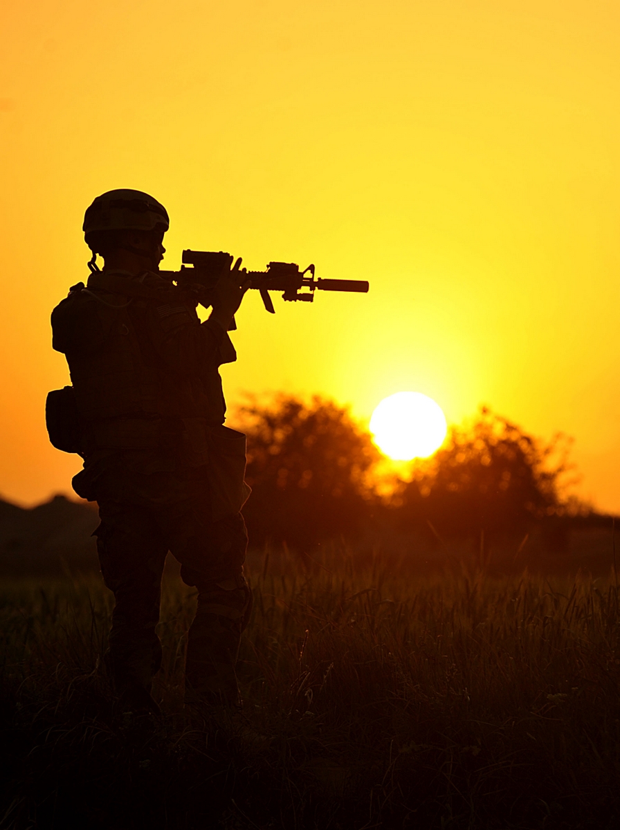 A U.S. Marine pulls security near a poppy field in Peyo as Marines and Afghan soldiers patrol ...jpg