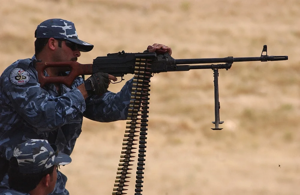 A_Kurdish_Peshmerga_officer_fires_a_PKM_in_Mosul_.webp