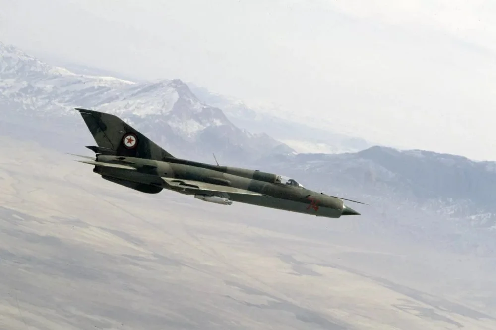 Afghan MiG-21FL (74 red) inflight (1980s).webp