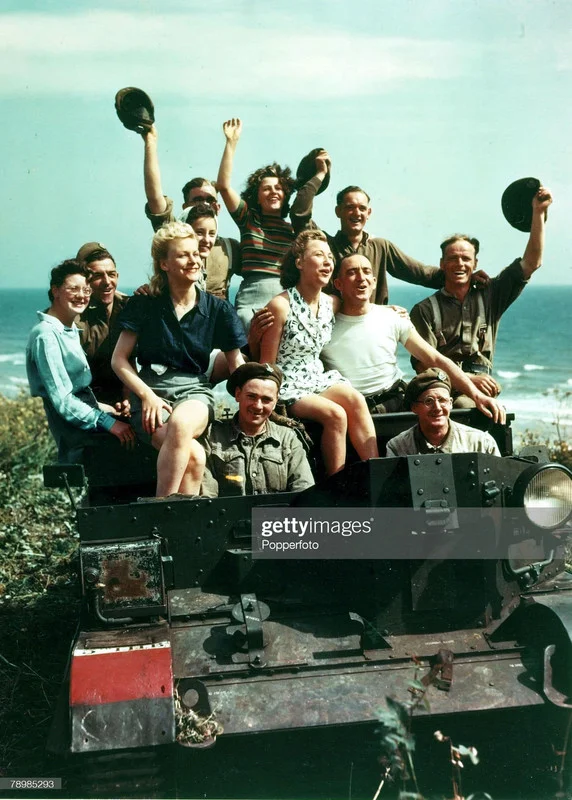 ain-Soldiers-and-girls-pose-in-a-Universal-Carrier.webp