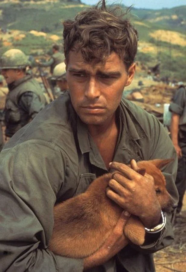 American cradling dog while under siege at Khe Sanh, Vietnam, 1968.webp