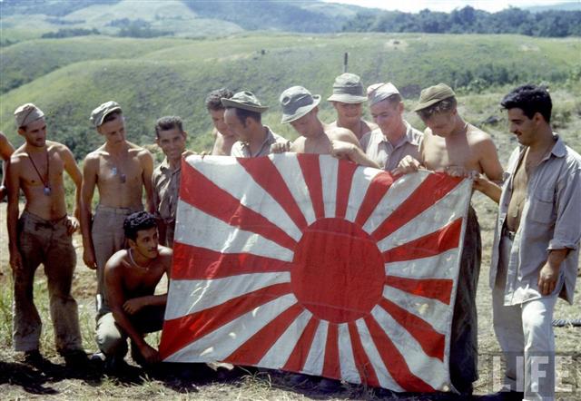 American soldiers holding captured Japanese flag on Guadalcanal.jpeg