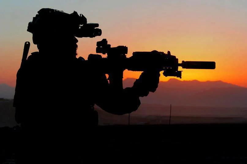 An Australian Army soldier from Special Operations Task Group prepares for a night mission.jpg