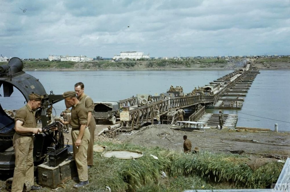 British 8th Army vehicles cross a pontoon bailey bridge.jpg