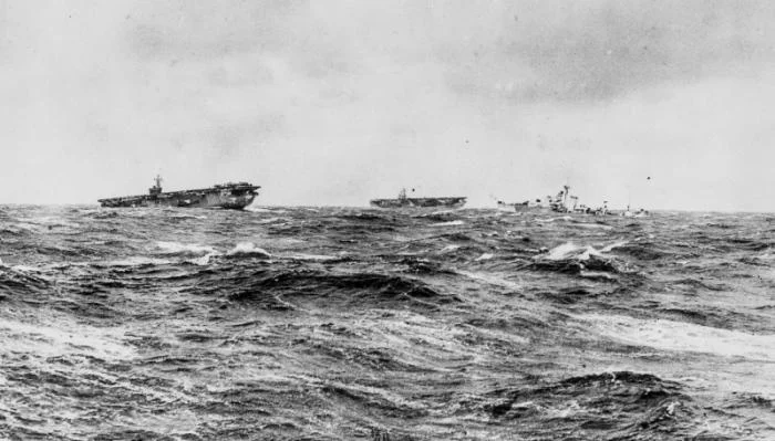 British escort carriers Emperor and Strike a destroyer in a stormy sea while escorting a conv...webp