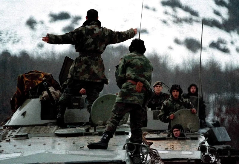 crews of Yugoslav Army armored vehicles listens to their commanding officer near Podujevo, Su...jpeg