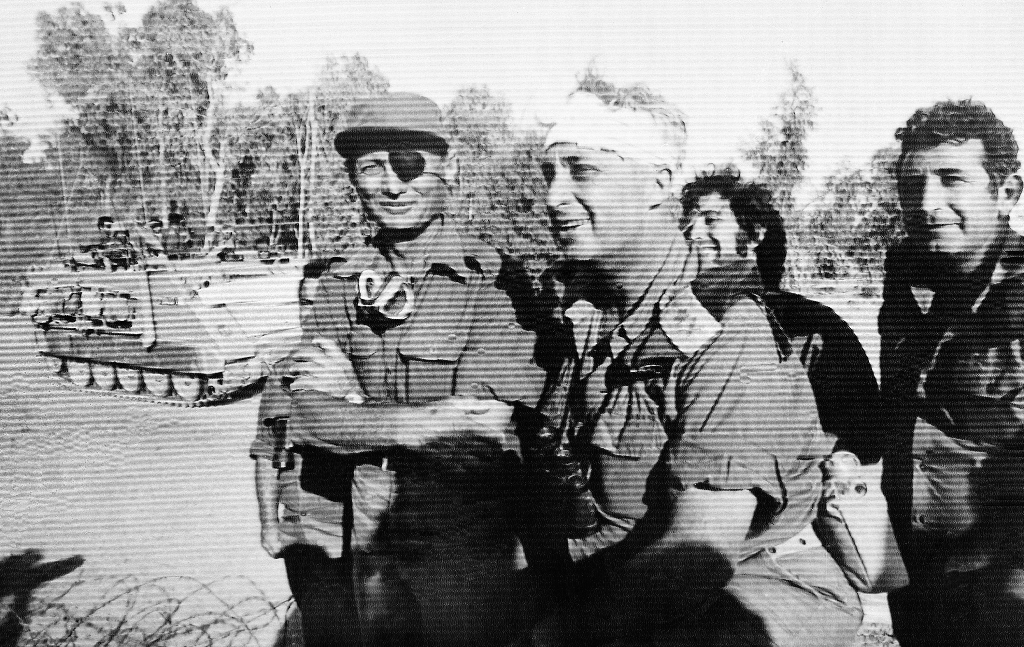 Defense Minister Moshe Dayan, left, and Maj. Gen. Ariel Sharon, second from right, who suffere...jpg