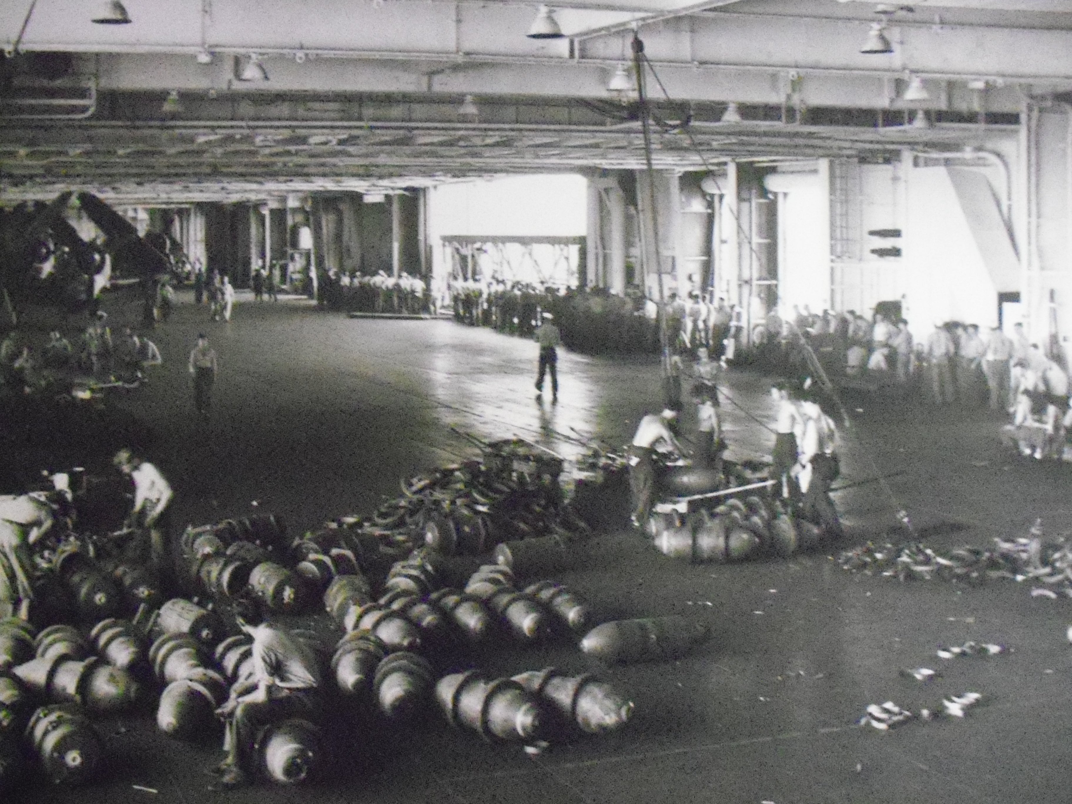 Essex CV-9 079 MP Munitions handling in the hangar bay with the chow line in background..JPG