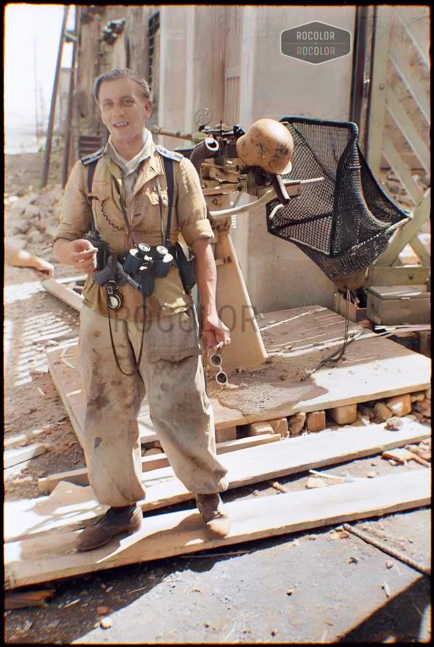 German infantryman of the Panzer-Grenadier-Regiment Hermann Goering in front of a 2 cm FlaK 2...webp