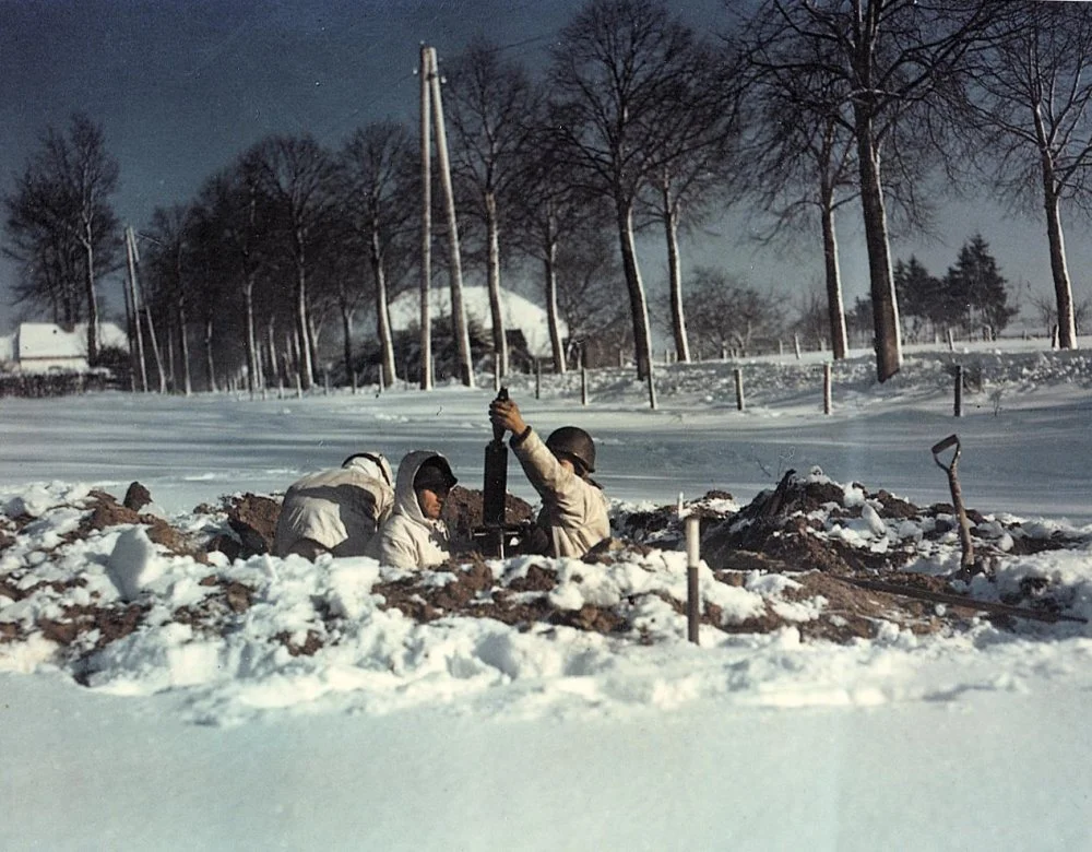 GI mortar team prepares to fire on the retreating Germans From a foxhole in the Snowy Hellhol...webp