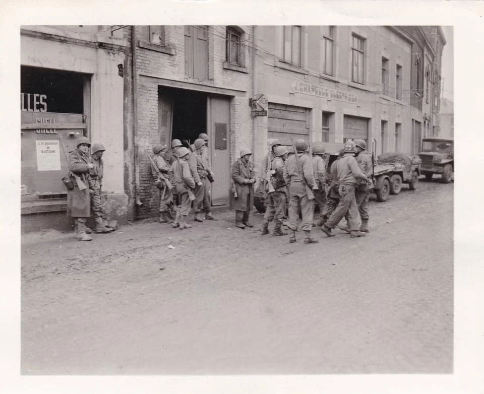 nfantrymen of the 1st US Army gather in Bastogne Belgium to regroup after being cut away from...webp