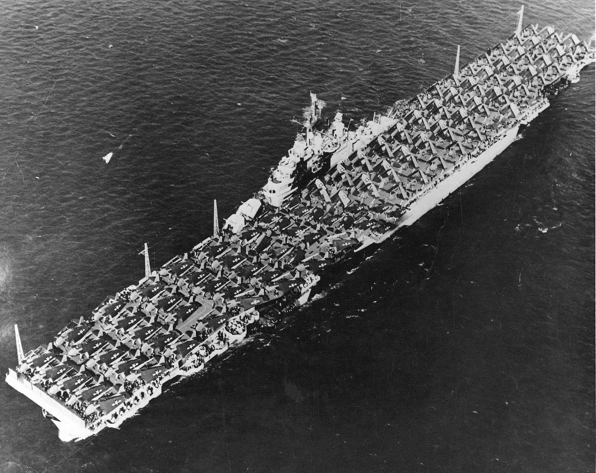 Overhead view of the carrier Essex (CV 9) steaming in the Pacific with her flight deck packed...webp