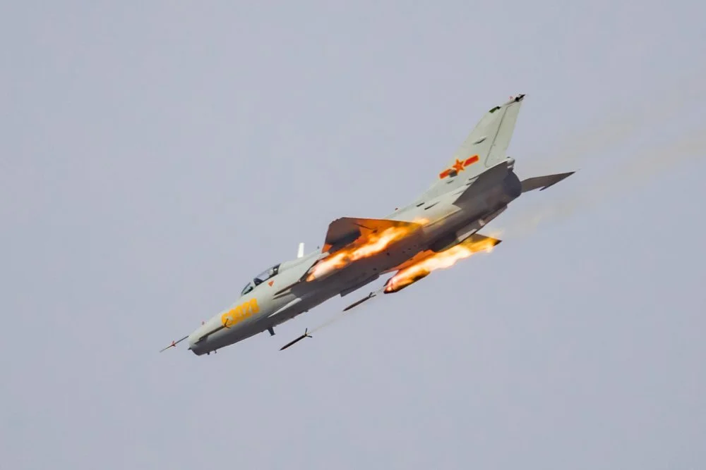 PLAAF J-7 of 21st AB at Yanqing AP firing rockets.webp