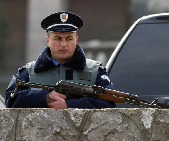 POLICEMAN HOLDS WEAPON DURING POLICE RAID ON HOUSE OF POPULAR SERBIAN FOLK STAR SVETLANA RAZN...webp