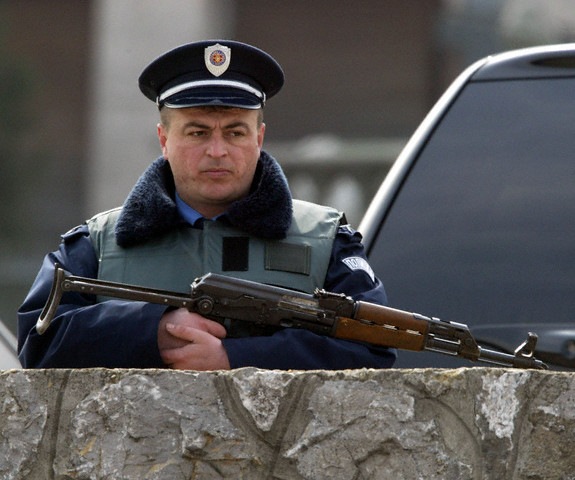 POLICEMAN HOLDS WEAPON DURING POLICE RAID ON HOUSE OF POPULAR SERBIAN FOLK STAR SVETLANA RAZNA...jpg