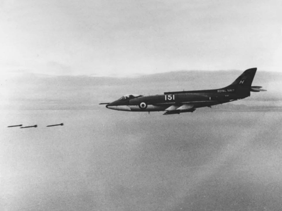 Royal Navy Scimitar F.1 (151) firing rockets, based on HMS Hermes.webp