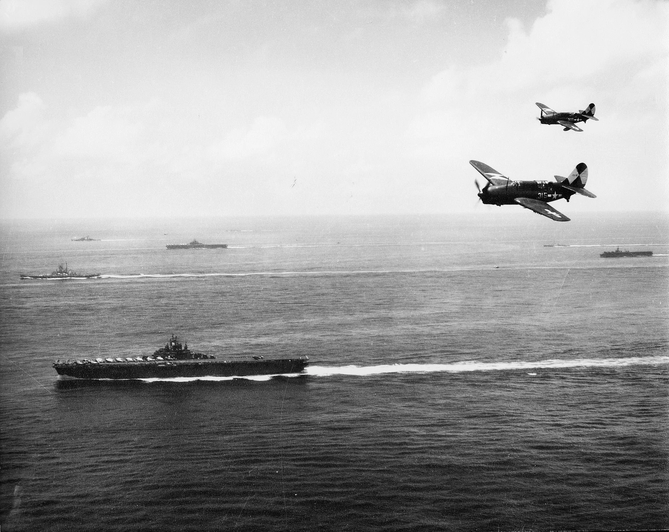 SB2C-4's of VB-83 with task group 38.3 off Okinawa with  ESSEX in foreground March-Sept 1945.jpg