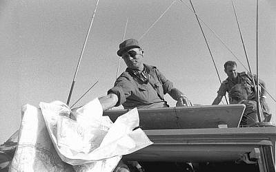 Then-defense minister Moshe Dayan visits the Sinai Peninsula during the Yom Kippur War, on Oct...jpg