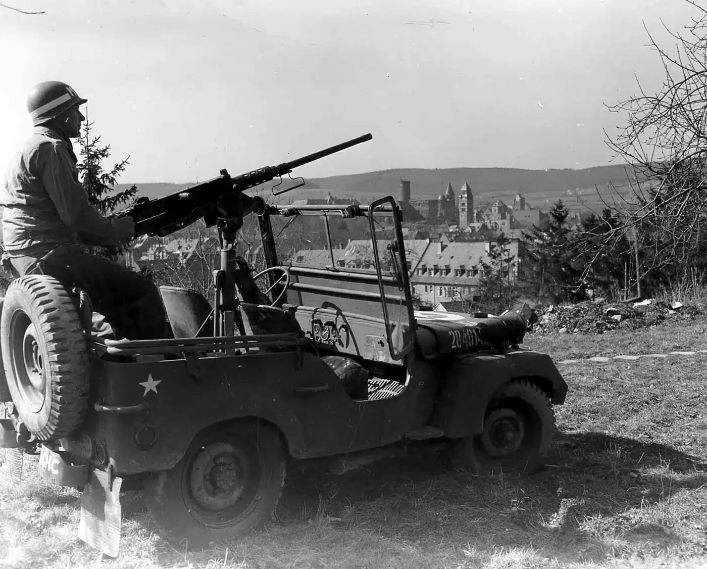 United-States-Army-MP-mans-M2-Browning-machine-gun-mounted-in-a-Jeep-during-World-War-II-in-G...webp