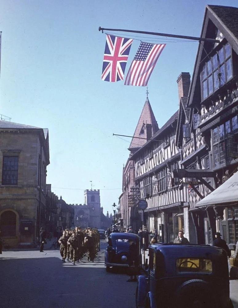 US Personnel march down a street in Stratford-upon-Avon, England - April 1944.webp