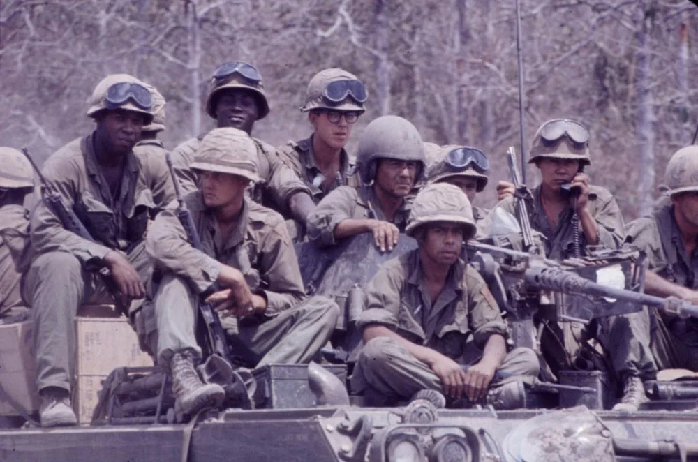 US Soldiers ride on an M113 APC.webp