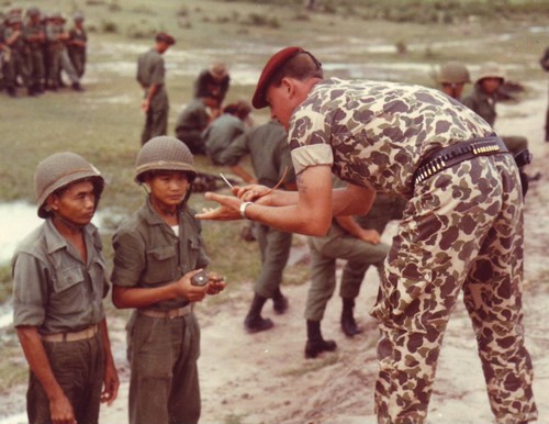 Vietnamese Rangers receive a course of instruction on demolitions from an advisor to the 77th ...jpg