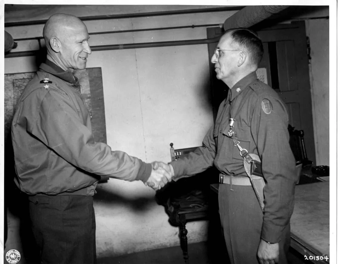 William_H._Simpson_shake_hand_with_BG_William_K._Harrison_Jr.webp