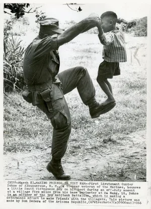 DANANG 1966 - MARINE IN VIETNAM PLAYS WITH CHILD.webp