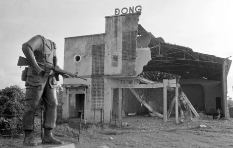 beheaded statue of American soldier stands next to a bombed-out theater in the district town ...webp