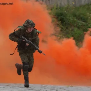 Polish soldier uses smoke to hide his position