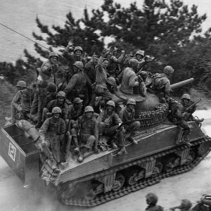 Sherman tank carrying passengers