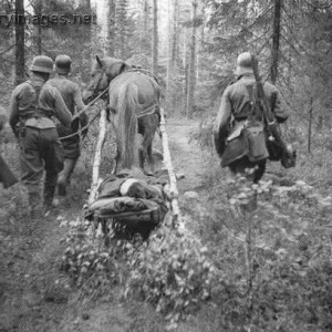 Wounded soldier being transported in woods