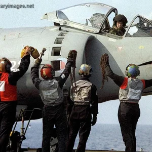 Maintainers showing the ground locks to the Pilot