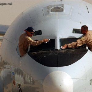Pilots clean their windshield before taking off