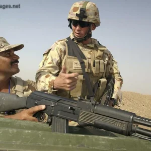 Warrant Officer watching over an Iraqi soldier