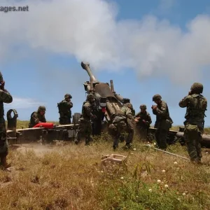 Marines fire off a round from the Howitzer