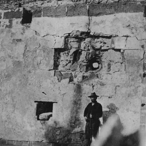 Sentry poses before a shell hole in the fort