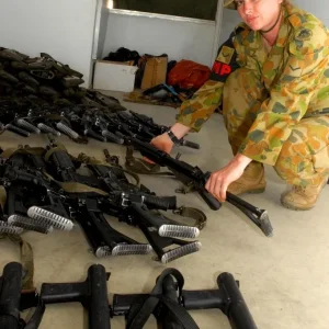 Lance Corporal displays confiscated weapons in Dili