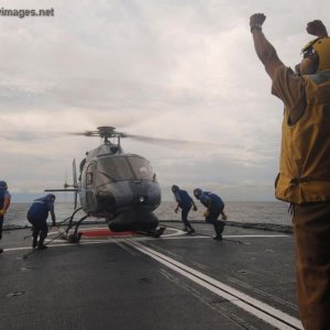 Sailors ready an AS 555 helicopter for flight