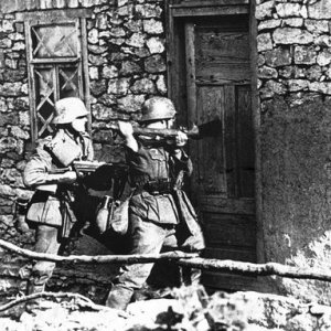 German soldiers forcing their way into a snipers hideout where Russians had been firing upon advancing German troops (1st September, 1941)