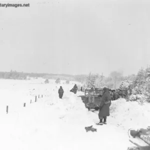 Medics jeeps laboring through narrow cuts in snow