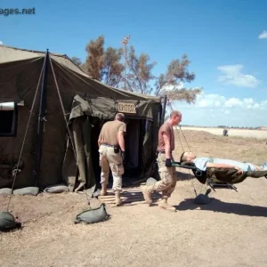 Aeromedical-evacuation technicians carry a patient