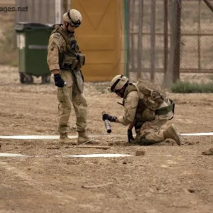 U.S. Navy Sailors dig up a rocket