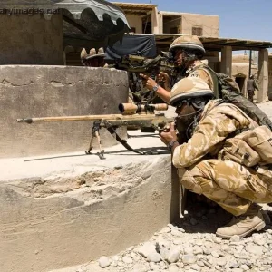 A sniper team watches the street